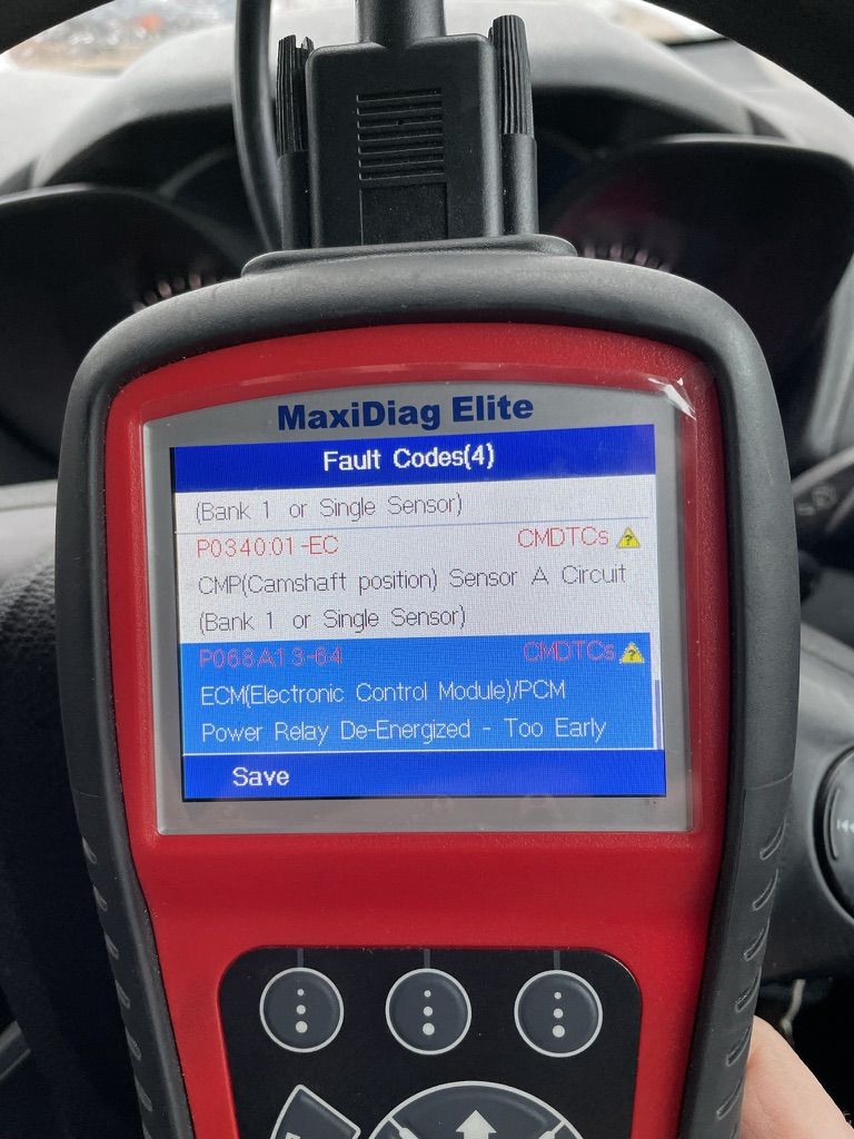 Scanner screen with P0340 camshaft sensor code stored alongside an ECM power relay fault