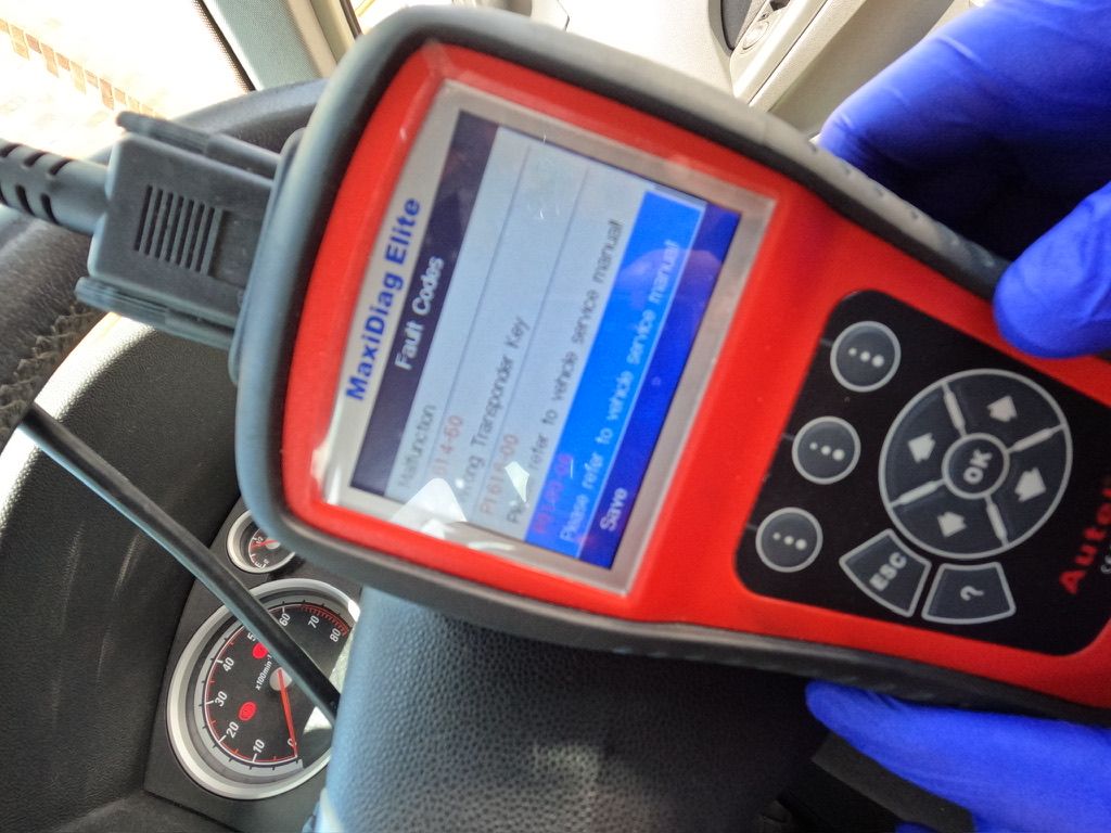 Reading fault codes with an Autel MaxiDiag scanner plugged into a van's OBD port