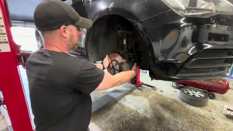 Audi front brake disc and caliper exposed with the wheel removed