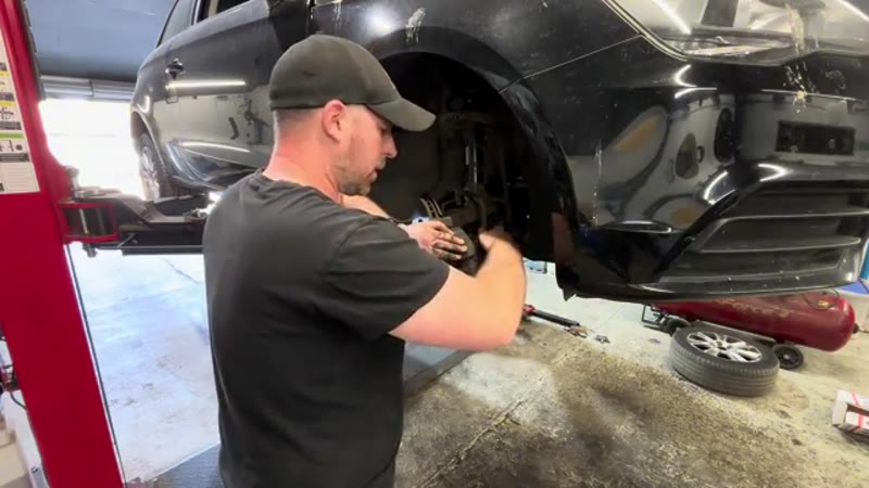 Refitting the Audi brake caliper and tightening the guide pins