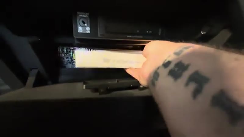 Sliding the new pollen filter into the Audi Q3 housing with the airflow arrow facing down