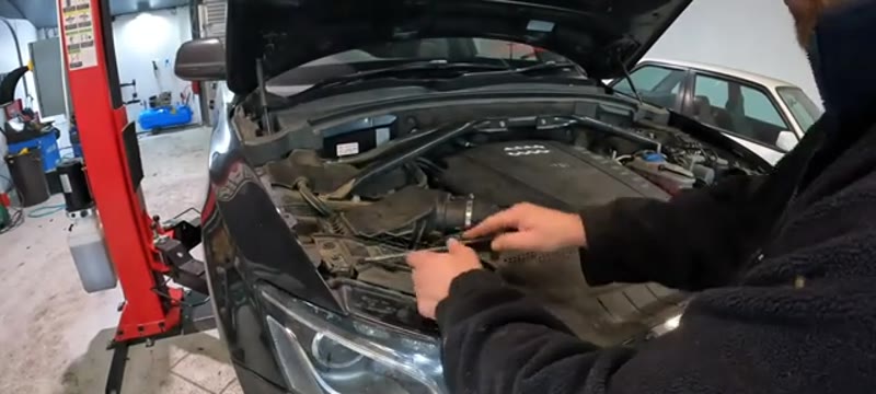 Removing the plastic trim clips from the top panel above the Audi Q5 headlight