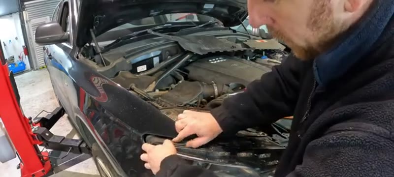 Sliding the Audi Q5 headlight forward on its lower rail to create access