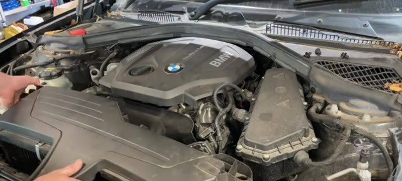Lifting the airbox assembly out of the BMW 1 Series 116d engine bay
