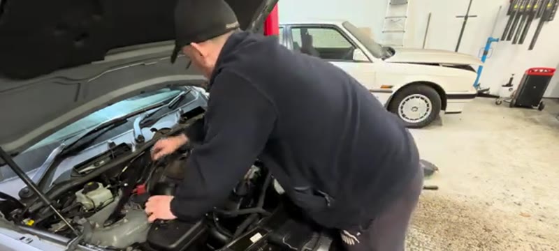 Unplugging the sensors and removing the cross-brace on the BMW 335i
