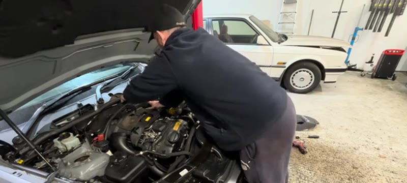 Wiggling the large engine cover out of the BMW 335i engine bay