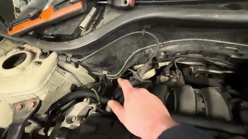 Disconnecting the throttle body elbow pipe to improve access on the BMW Mini