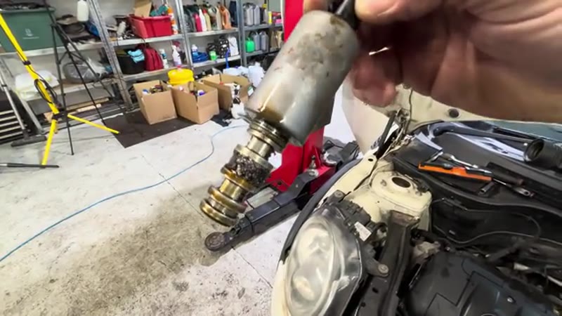 The Mini Vanos solenoid removed, its gauze filter clogged with metal filings
