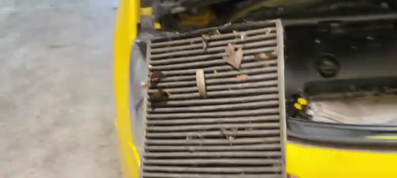 Old, dirt-clogged pollen filter removed from a Citroën DS3, held up to show how much debris it has collected