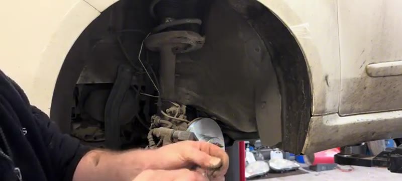 Cleaning the rust off the main caliper pin before refitting it to the Fiat 500 caliper