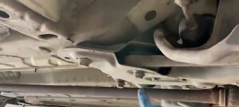 Removing the lower wishbone mounting bolts from the Fiat 500 subframe