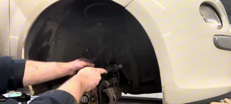 Removing the two lower bolts that hold the Fiat 500 shock absorber to the hub