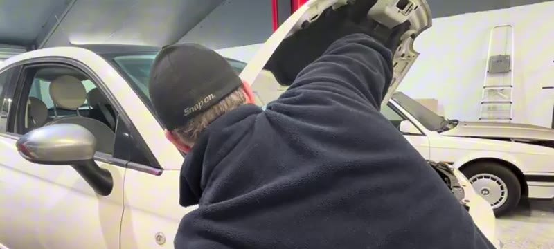 Undoing the 19mm top mount nut under the bonnet of the Fiat 500