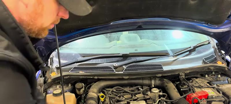 Removing the wiper arms and scuttle panel on a Ford Fiesta to reach the bulkhead
