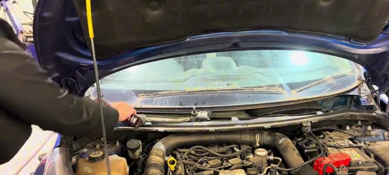 Undoing the 10mm bolts on the Ford Fiesta inner scuttle section
