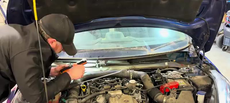 Reaching down the Ford Fiesta bulkhead to release the clutch hydraulic pipes