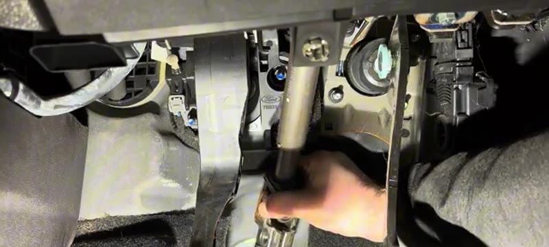 Lifting the Ford Fiesta steering column out of the way inside the cabin