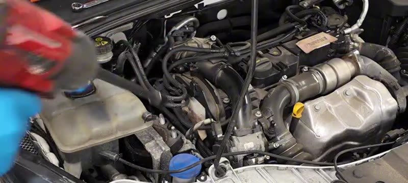 Undoing the engine mount bolts on the Ford Focus with the engine supported underneath