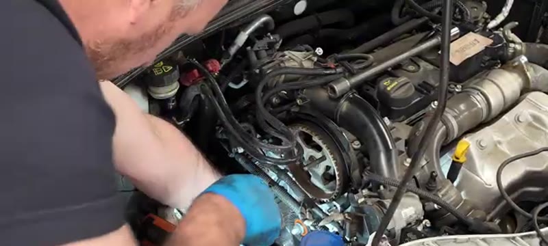 Releasing the cam belt tensioner with a 13mm spanner on the Ford Focus