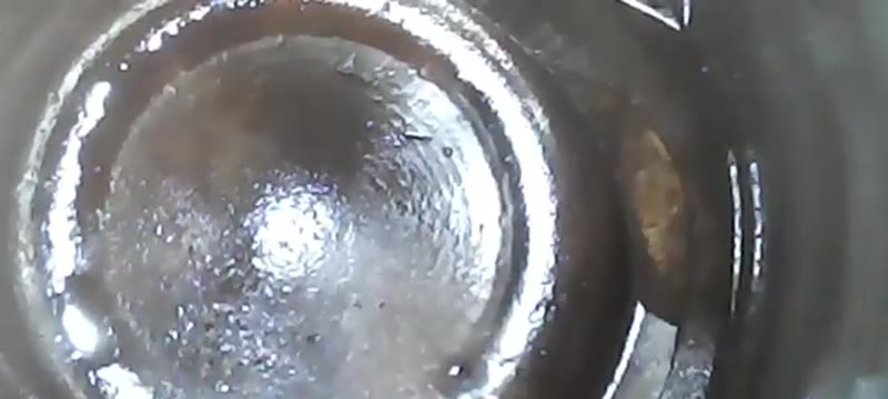 Borescope view inside a Ford Focus cylinder showing coolant sitting on the piston crown