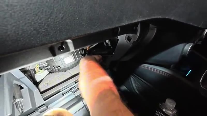 Undoing the T15 Torx screws behind the glove box on the Ford Kuga