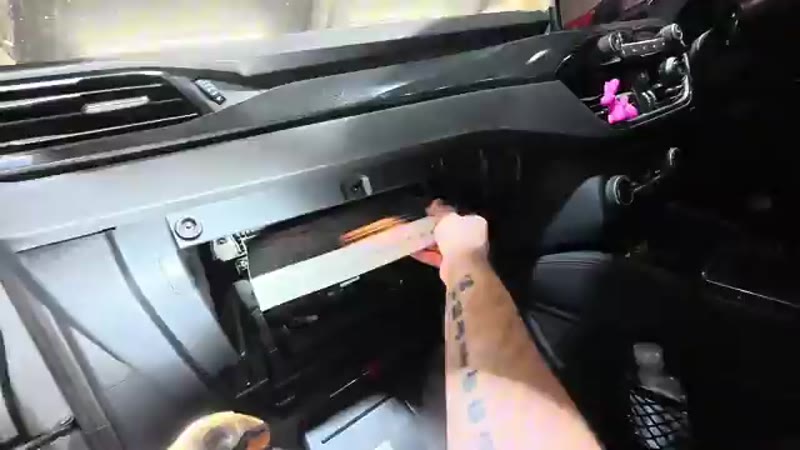 Sliding the old pollen filter out of its housing on the Ford Kuga