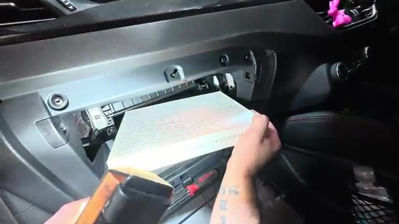 Fitting the new pollen filter with the airflow arrow pointing down on the Ford Kuga