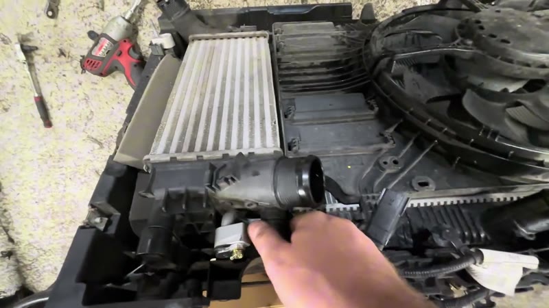 Refitting the intercooler into the rebuilt Ford Puma radiator pack