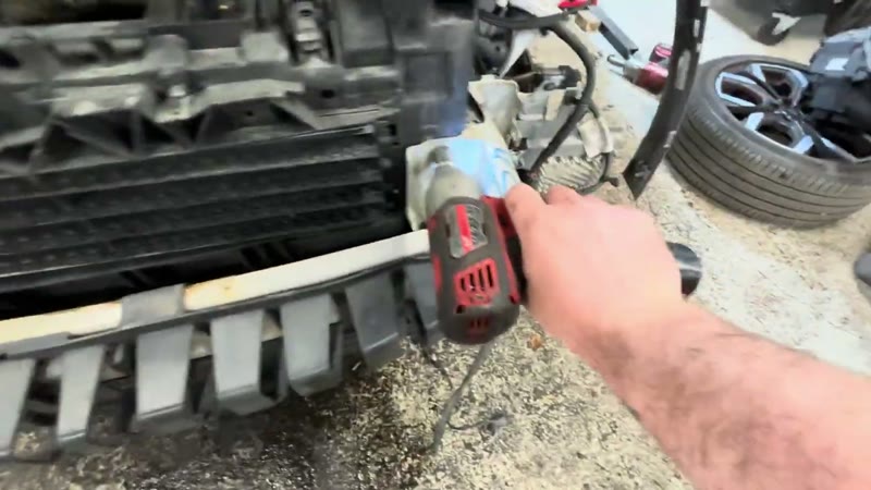 Bolting the front end back together on the Ford Puma after refitting the radiator pack