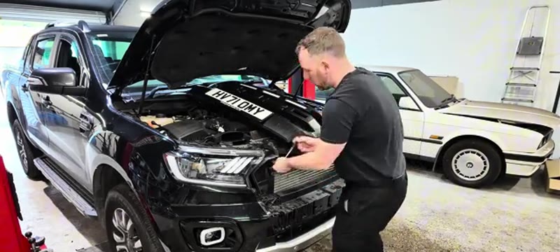 Undoing the 8mm bolt in the plastic headlight surround on the Ford Ranger