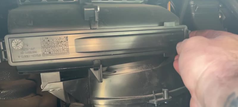 Pollen filter housing door hinged open behind the Transit glove box