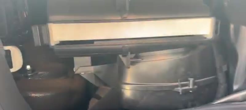 New pollen filter sliding into position in the Ford Transit filter housing