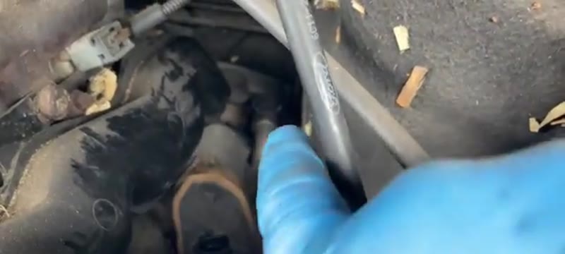 Pointing out the EGR valve electrical connector in the Ford Transit engine bay