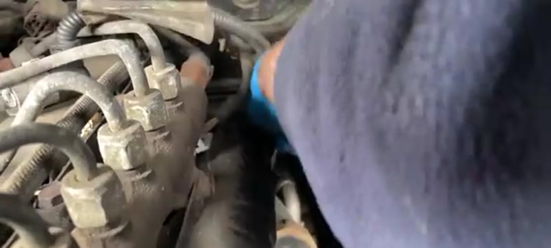 Reaching behind the inlet manifold with a quarter-drive socket and extension to undo the hidden EGR valve bolt