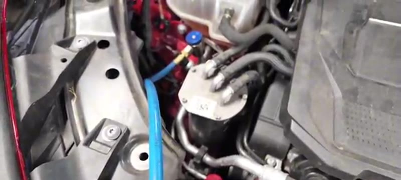 Air con machine hooked up to the regas port to refill the system with R-1234YF