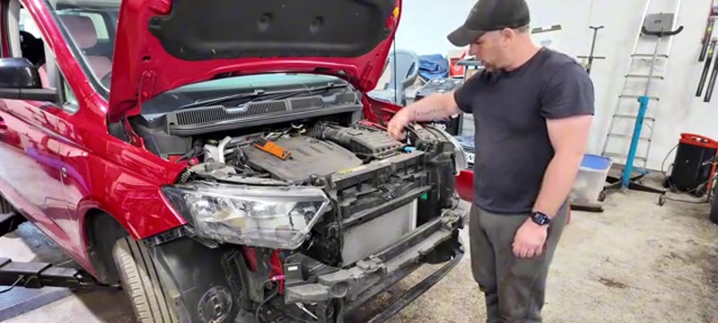 Unclipping the bonnet release cable from its holder behind the front panel