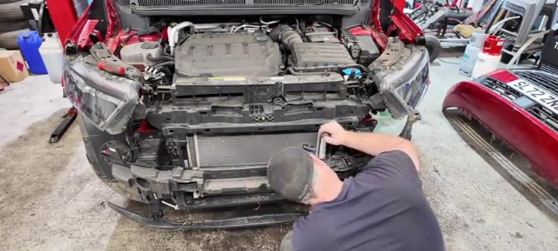 Releasing the upper clips so the condenser can slide out from below