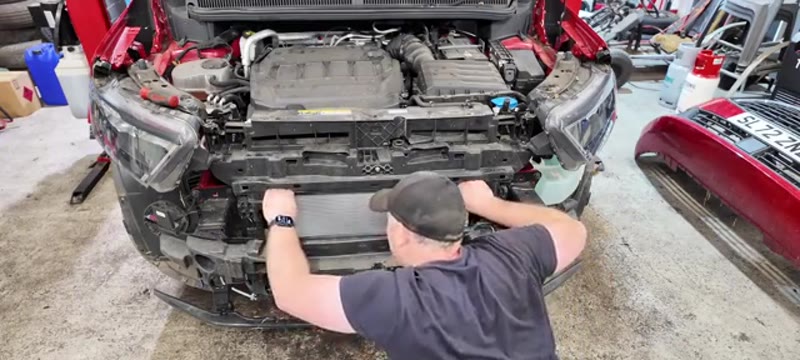 Sliding the new air con condenser into position on the Ford Transit Connect