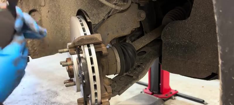 Fitting the new brake pads into the caliper carrier with a smear of copper slip