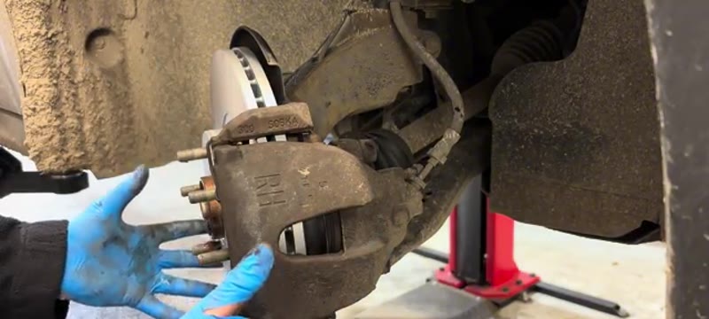 Checking the reassembled caliper moves freely before the wheel goes back on