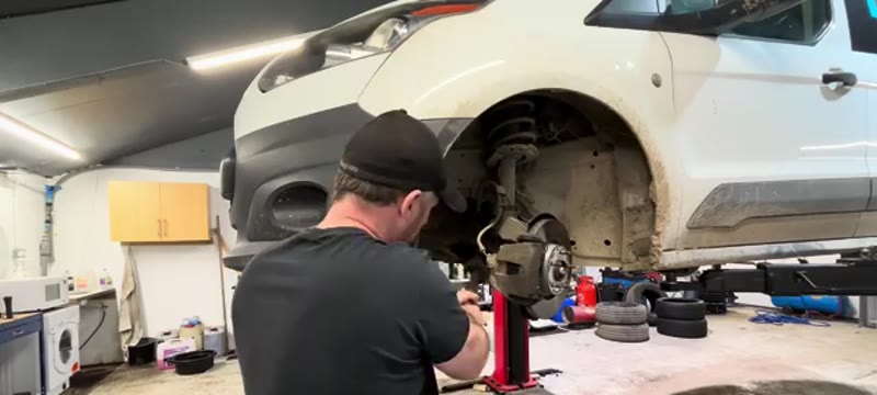 Knocking the lower arm pinch bolt out of the hub on the Transit Connect