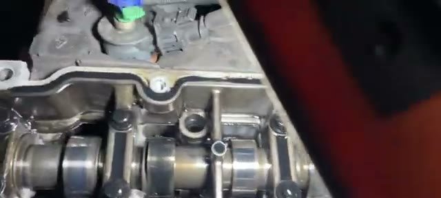 Under the Transit Connect rocker cover showing cam followers detached from the camshaft lobes