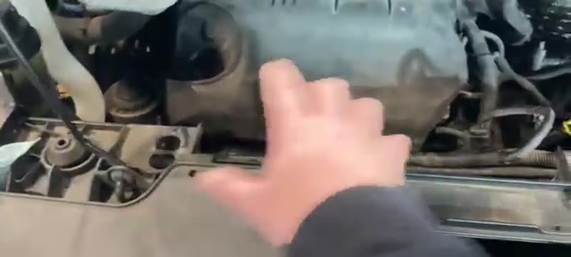 Unclipping the air box on top of the Ford Transit Custom engine at the start of the stripdown