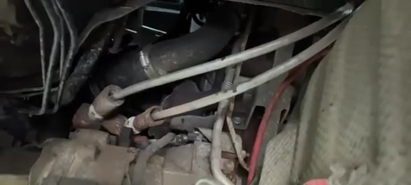 Underside view of the lower arms and brace bar that come off before the gearbox