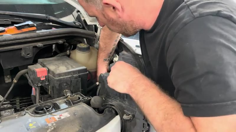 Carefully wiggling the headlight unit forward and out of the Ford Transit Custom