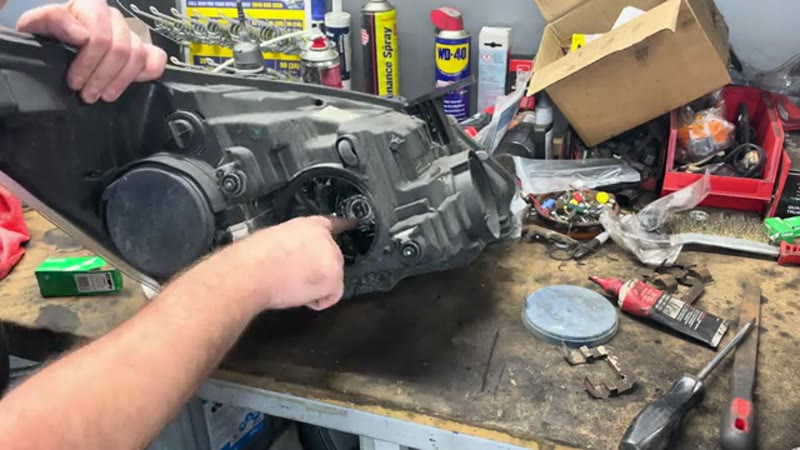 Pushing the new H7 bulb into the headlight holder, holding it by the base to keep fingerprints off the glass