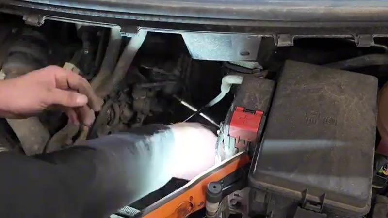 Undoing the three 8mm bolts that hold the vacuum pump to the engine with a quarter-drive ratchet and extension