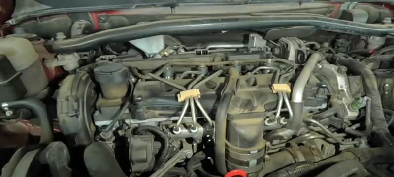 Diesel engine bay with the cover removed, ready for glow plug testing once the engine has cooled