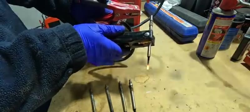 Glow plug tip glowing during a bench test, confirming the plug is working
