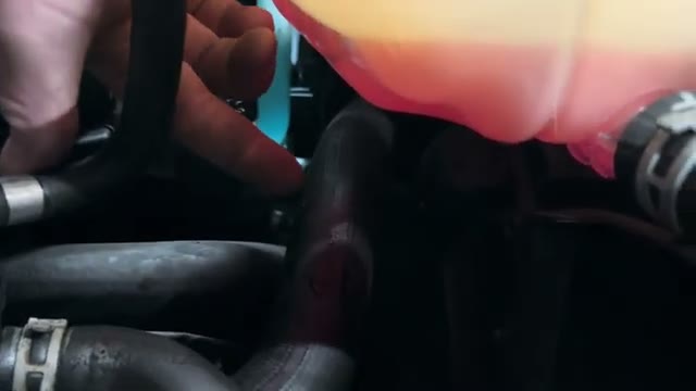 Pinhole leak point at the bottom of the coolant header tank above the pipe